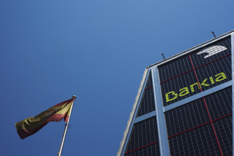 A Spanish flag flies next to the headquarters of Bankia bank in Madrid