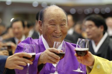 Evangelist Reverend Moon drinks a toast with his family members during his birthday party in Gapyeong