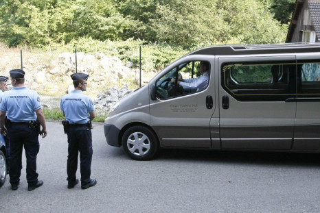 French gendarmes escort hearses leaving La Combe d'Ire raoad in Chevaline