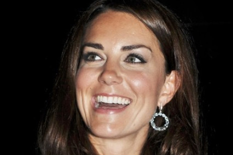 Kate Middleton smiles before the opening ceremony of the London 2012 Olympic Games at the Olympic Stadium July 27, 2012. The Duchess of Cambridge has been credited for letting London win the top global fashion capital for consecutive two years. REUTERS/Jo