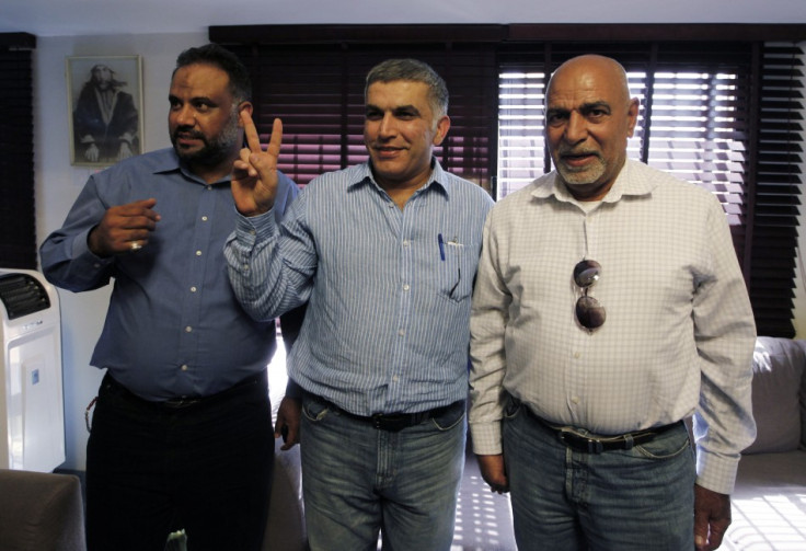 Bahrain human rights activist Nabeel Rajab flashes a victory sign as he poses for photographers with his family members