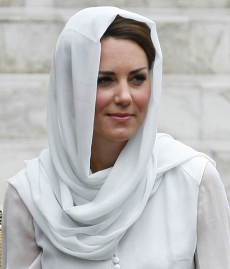 Catherine, Britain's Duchess of Cambridge, wears a shawl around her head as she sits on a chair after removing her shoes before entering As-Syakirin Mosque at KLCC in Kuala Lumpur, September 14, 2012. (Photo: REUTERS)