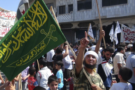 A member of the Free Syrian Army holds a flag during a protest against Syria's President Bashar al-Assad