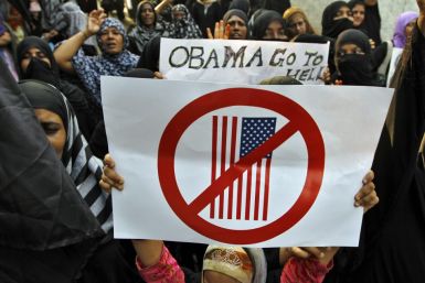 Muslim demonstrators hold placards during an anti-U.S. protest against a film