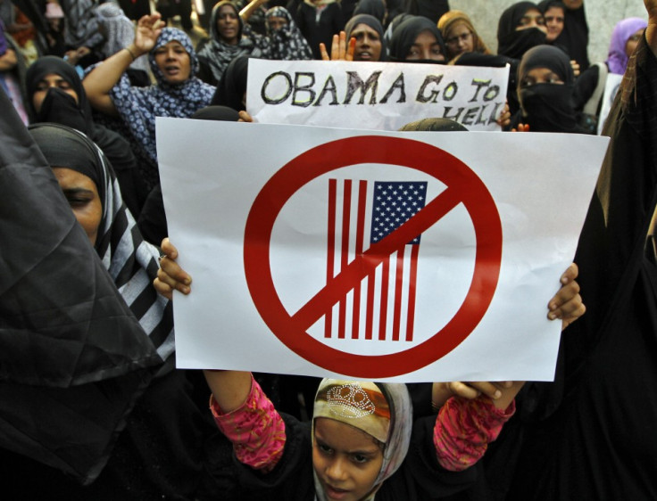 Muslim demonstrators hold placards during an anti-U.S. protest against a film