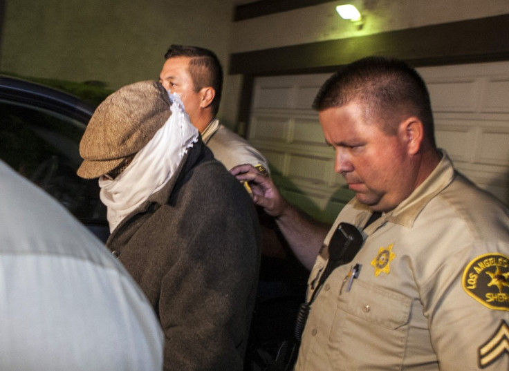 Nakoula Basseley Nakoula is escorted out of his home by Los Angeles County Sheriff's officers in Cerritos, California