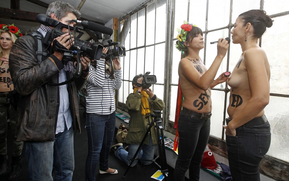 Activists from the topless womens rights group Femen prepare for the inauguration of the training camp in Paris