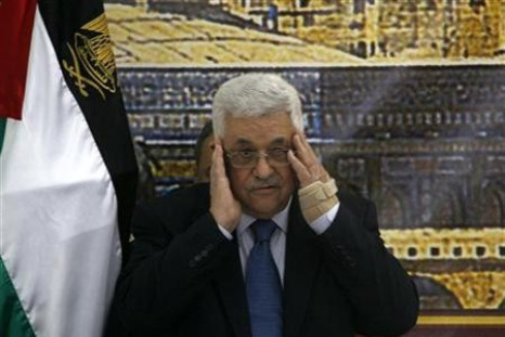 Palestinian President Mahmoud Abbas prays before the start of a meeting in Ramallah