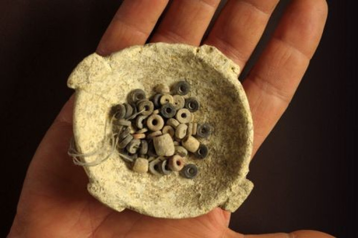 A small stone bowl containing more than 200 black, white and red stone beads was discovered in Ein Zippori in northern Israel. (Photo: Clara Amit, Israel Antiquities Authority)
