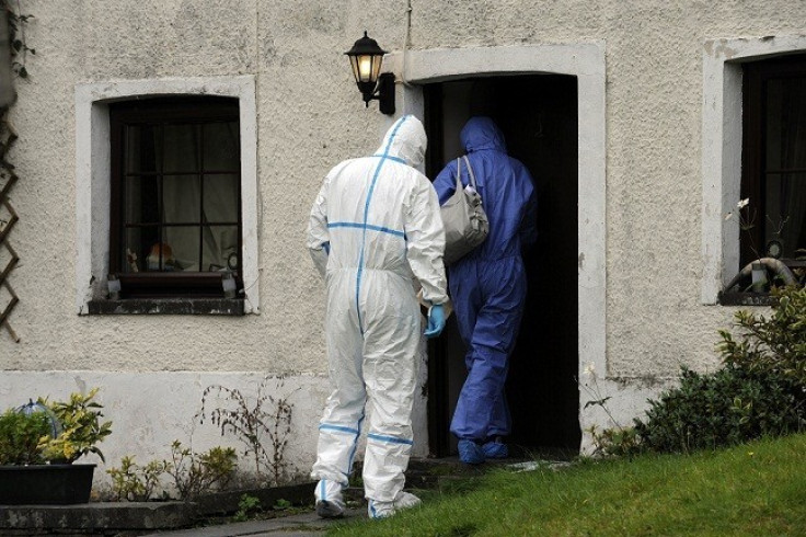 Police forensic officers enter Mark Bridger's house (Reuters)
