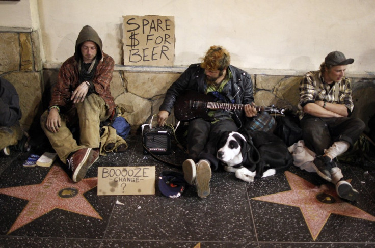 Homeless men sitting on Hollywood Walk of Fame stars on Hollywood Boulevard beg for money to buy beer in Hollywood (Photo: Reuters)