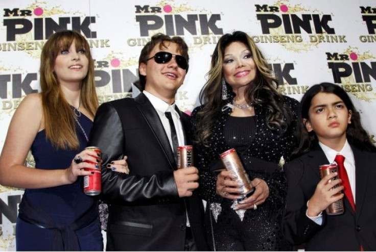 Paris, Prince and Blanket, children of the late Michael Jackson, pose next to their aunt La Toya Jackson at the Mr. Pink Ginseng Drink launch party in Beverly Hills