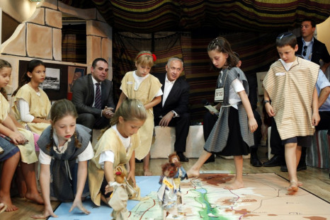 Israeli Prime Minister Netanyahu watches as students play an interactive game on their first day of school