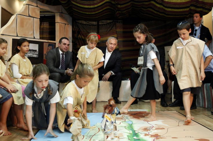 Israeli Prime Minister Netanyahu watches as students play an interactive game on their first day of school