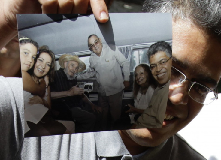 Venezuela's former vice president Elias Jaua shows a picture of himself and former Cuban leader Fidel Castro in Havana