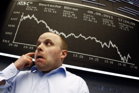 A trader reacts in front of the DAX index board at Frankfurt's stock exchange