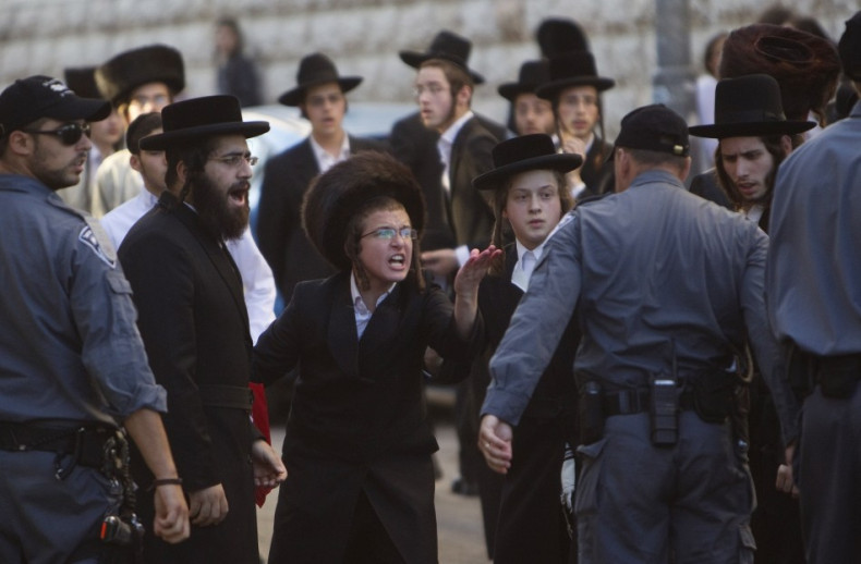 Ultra-Orthodox Jews shout at a policeman during a protest against the opening of a road on the Sabbath
