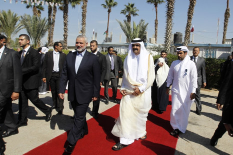 Hamas Prime Minister Haniyeh walks with the Emir of Qatar in Rafah