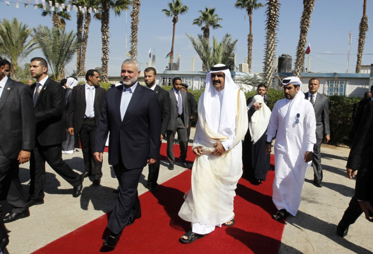 Hamas Prime Minister Haniyeh walks with the Emir of Qatar in Rafah