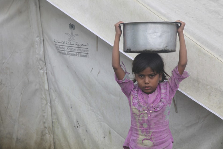 A girl balances a pot on her head at a camp for internally displaced persons in Myanmar's Rakhine state