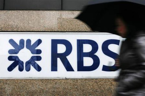 A woman walks past the Royal Bank of Scotland's offices in the City of London