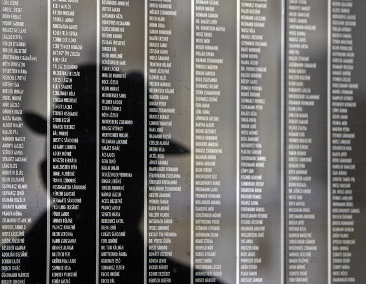 Hungarian man is reflected on a wall containing the names of victims at Budapest's Holocaust Memorial Centre