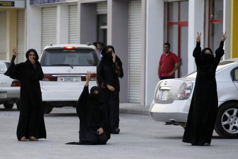 Anti government protesters shout slogans as they try to enter al-Eker village