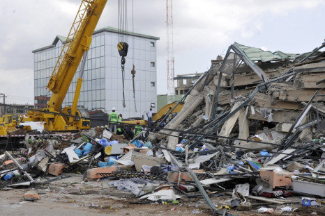 Rescue workers look for survivors from the debris of a collapsed building rented by Melcom Ltd in Accra