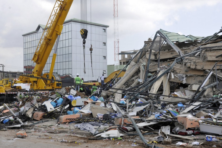 Rescue workers look for survivors from the debris of a collapsed building rented by Melcom Ltd in Accra