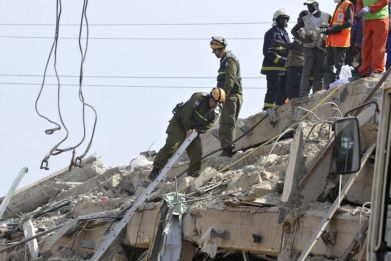 Members of an Israeli military team search for survivors among the debris of a collapsed shopping mall in Accra (Reuters)