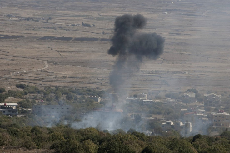 Smoke rises after shells exploded in the Syrian village of Bariqa, close to the ceasefire line between Israel and Syria,