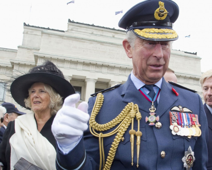 Britain's Prince Charles waves alongside his wife Camilla, Duchess of Cornwall as they attend the Armistice Day Commemoration at the Auckland War Memorial Museum