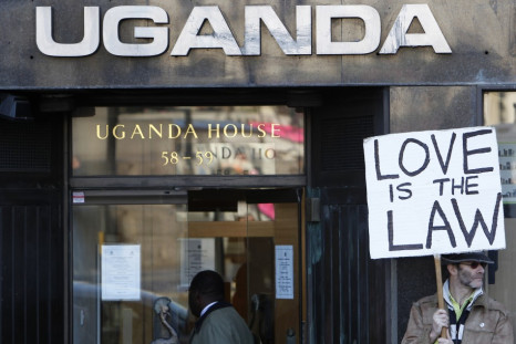 An activist holds a banner during a gay rights protest outside Uganda House in Trafalgar Square in London