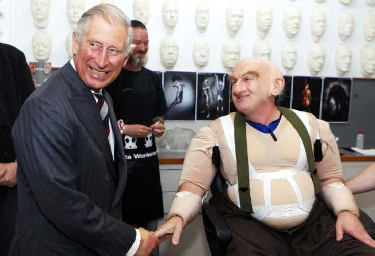 Britain's Prince Charles meets actor Peter Hambleton, who is dressed as Gloin the dwarf in The Hobbit movies, during a visit to the makeup department of film maker Peter Jackson's Weta Workshop in Wellington on his 64th birthday, November 14, 2012.