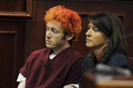 Colorado shooting suspect James Holmes (L) sits with public defender Tamara Brady during his first court appearance (Reuters)
