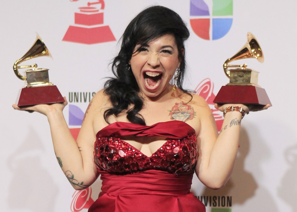 Carla Morrison poses backstage with the awards for best alternative album and best alternative song during the 13th Latin Grammy Awards in Las Vegas