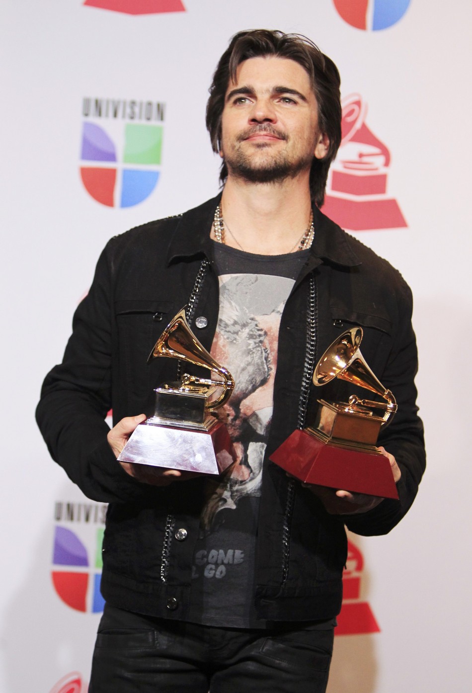 Juanes poses with awards for best long form music video and album of the year for MTV Unplugged during the 13th Latin Grammy Awards in Las Vegas