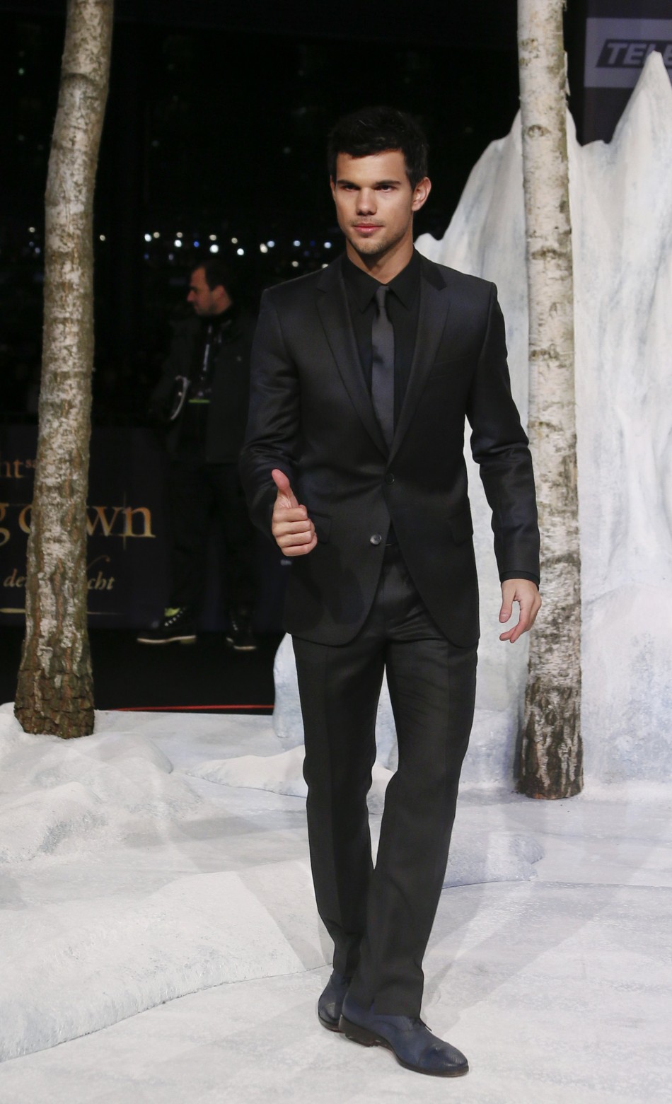Lautner poses for pictures before German premiere of The Twilight Saga Breaking Dawn Part 2 in Berlin