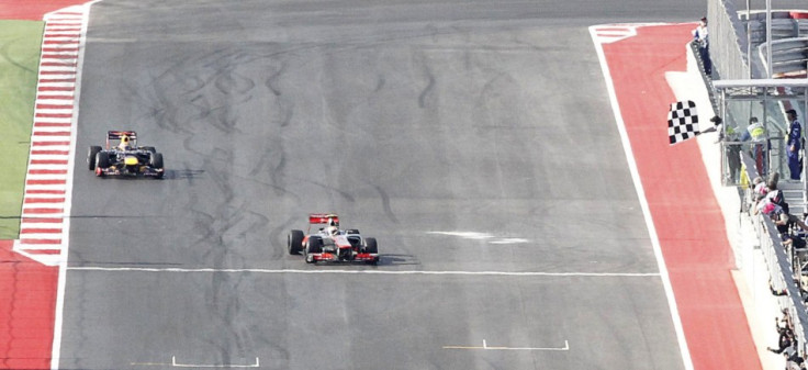 Hamilton crosses the finish line ahead of Vettel