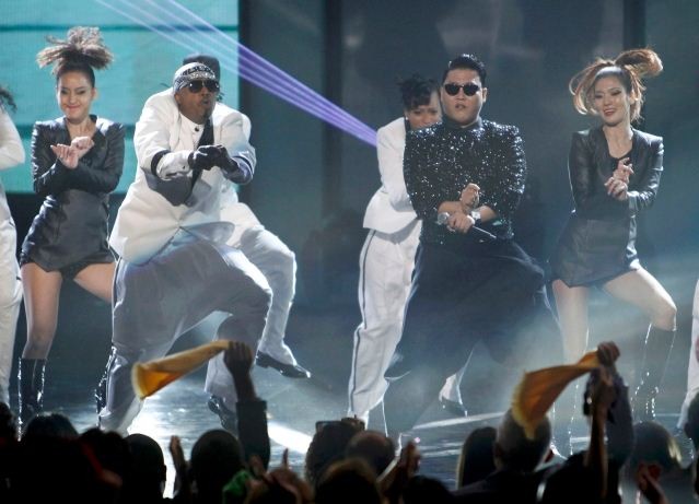 South Korean rapper Psy performs with MC Hammer at the 40th American Music Awards in Los Angeles