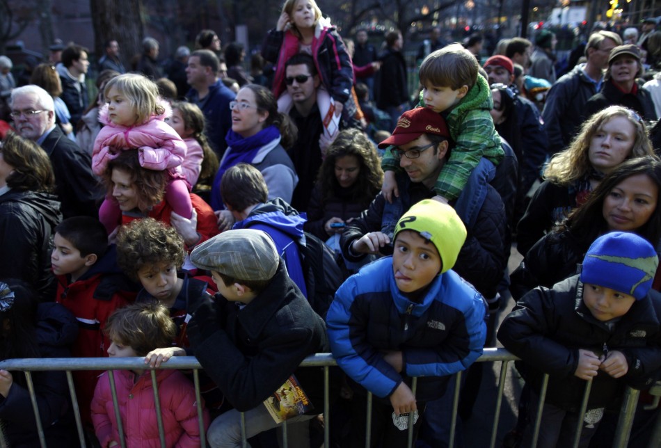 Families with children look at floats ahead of the Macys Thanksgiving Parade in New York