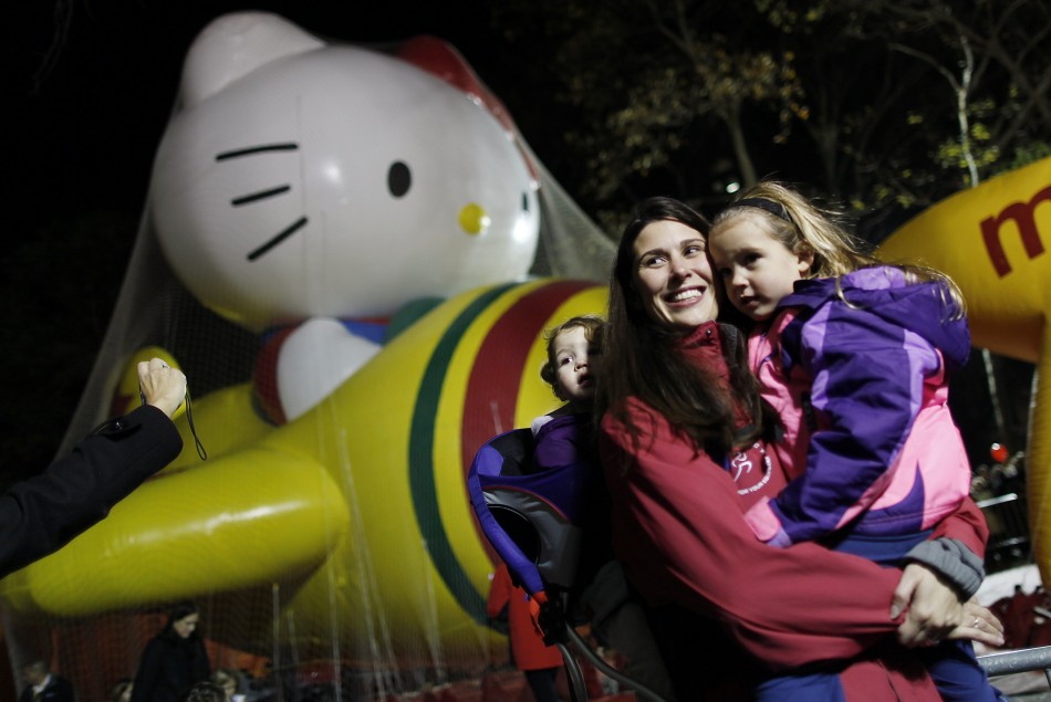 Tania Grove poses for a photo with her daughters Morgan and Abby in front of a Hello Kitty float ahead of the Macys Thanksgiving Parade in New York
