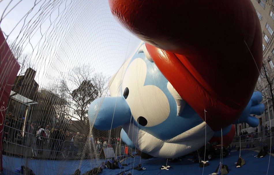 Balloon in the shape of Papa Smurf is held down by netting as it gets inflated with helium ahead of the Macys Thanksgiving Parade in New York