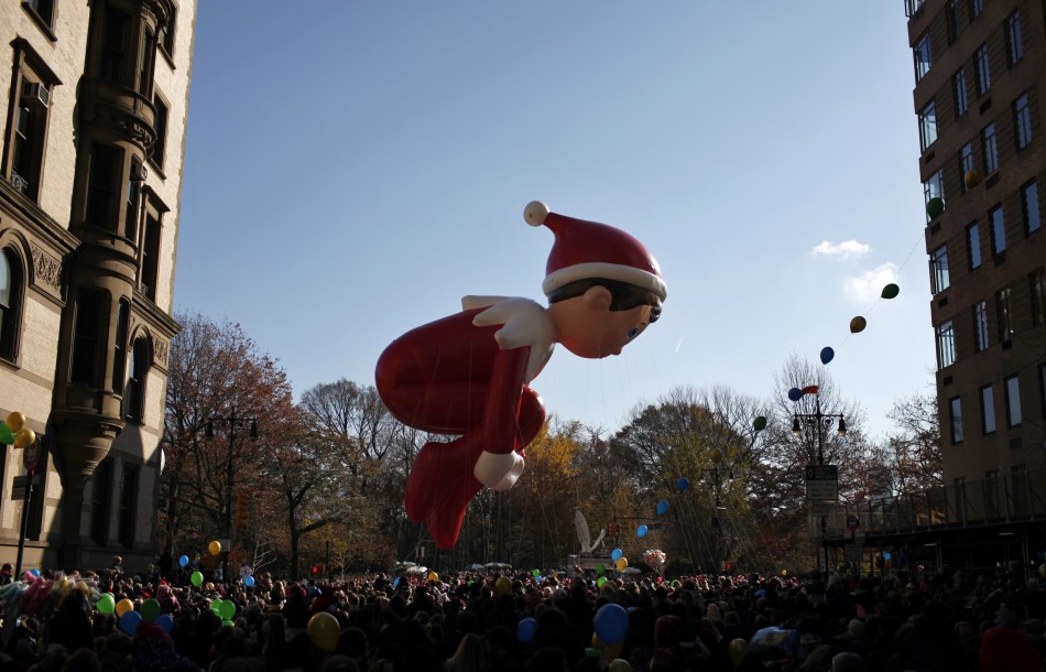 A balloon of the children's book character Elf on the Shelf floats past West 72nd street on Central Park West during the annual Macy's Thanksgiving Day parade in New York