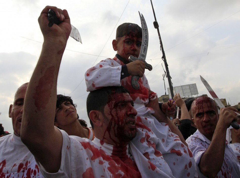 Shiite Muslim worshippers, stained by their own blood from self inflicted wounds
