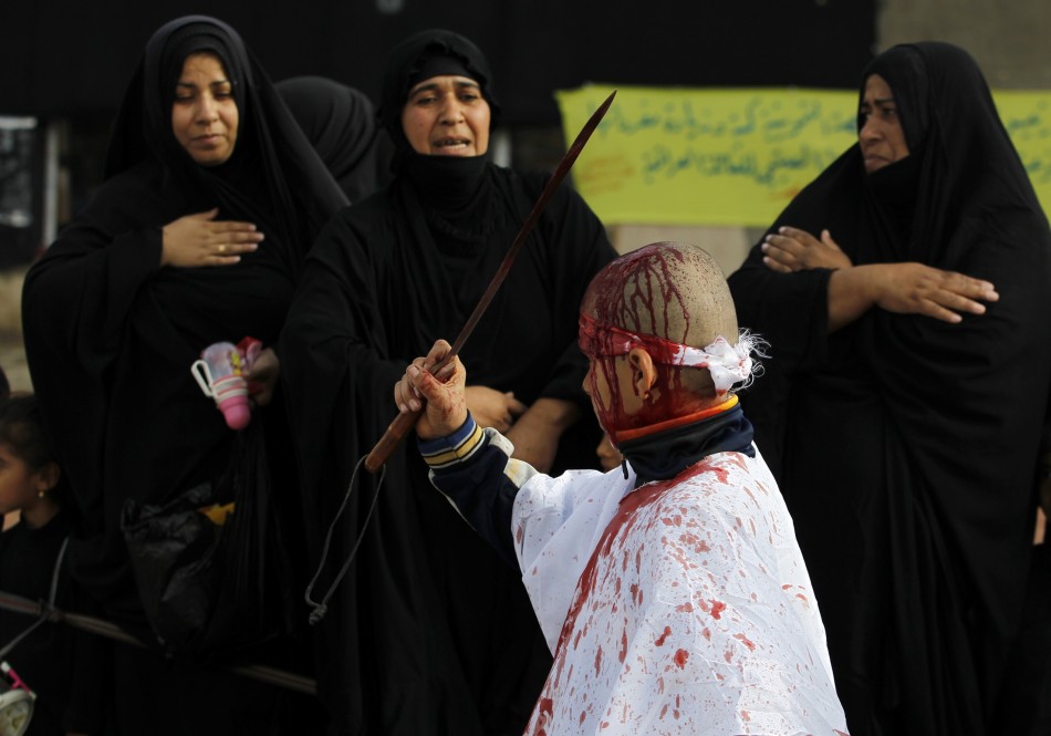 An Iraqi Shiite Muslim child gashes his forehead with a sword during a ceremony marking Ashura in Baghdad