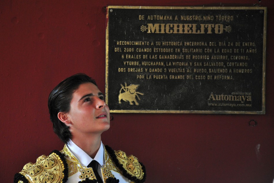 Mexicos bullfighter Michelito Lagravere poses next to a plaque about him at the Plaza Monumental bullring in Merida