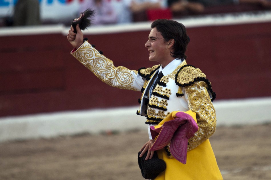 Mexican matador Michelito Lagravere holds up the ear he received for killing a bull