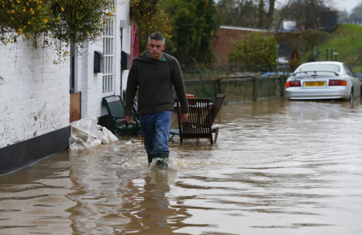 A man walks through floodwater  in Tewkesbury, south western England (Reuters)