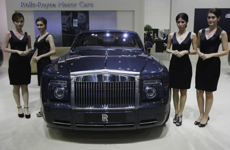 Models pose beside a Rolls-Royce Phantom Drophead Coupe during a media presentation (Photo: Reuters)